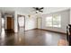 Spacious living room features laminate flooring and a ceiling fan at 6715 Wandering Way, Indianapolis, IN 46241