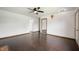 A bright living room with dark laminate flooring and a ceiling fan at 6715 Wandering Way, Indianapolis, IN 46241