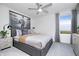 Comfortable bedroom featuring plush carpet, ceiling fan, window with backyard view, and a queen-sized bed at 6833 Jacone Dr, Brownsburg, IN 46112