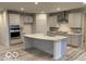 Modern kitchen features stainless steel appliances, gray cabinets, a spacious island and stylish countertops at 6833 Jacone Dr, Brownsburg, IN 46112