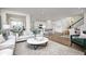 Bright and airy living space with hardwood floors, modern decor, and seamless flow into the kitchen at 6833 Jacone Dr, Brownsburg, IN 46112
