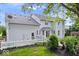 Sprawling backyard featuring a two-story home with a white picket fence and lush landscaping at 7056 E 171St St, Noblesville, IN 46062