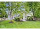 Two-story home with a fenced backyard, lush landscaping, and an upper-level balcony at 7056 E 171St St, Noblesville, IN 46062