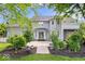 Exterior backyard of a two-story home featuring sliding glass doors, a patio, and green vegetation at 7056 E 171St St, Noblesville, IN 46062