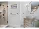 Stylish bathroom features a walk-in shower, vanity with sink and decorative wallpaper at 7056 E 171St St, Noblesville, IN 46062