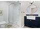 Stylish bathroom with glass-enclosed shower and a navy vanity with white farmhouse sink at 7056 E 171St St, Noblesville, IN 46062