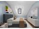 Cozy bedroom features cool blue walls, modern art, and unique architectural details at 7056 E 171St St, Noblesville, IN 46062