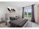 Bedroom featuring a neutral palette, a large window, and an art piece on the wall at 7056 E 171St St, Noblesville, IN 46062