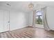 Minimalist bedroom with hardwood floors, vaulted ceiling, and large window offering a bright space at 7056 E 171St St, Noblesville, IN 46062