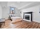 Well-lit bedroom boasts hardwood floors, a decorative fireplace, and ample natural light at 7056 E 171St St, Noblesville, IN 46062