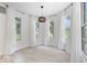 Sunlit breakfast nook with light wood flooring and large windows dressed with white curtains at 7056 E 171St St, Noblesville, IN 46062