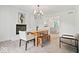 Bright dining room featuring a fireplace, wood floors, and adjacent kitchen at 7056 E 171St St, Noblesville, IN 46062