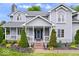 Charming two-story home with gray siding, covered porch, and well-manicured landscaping at 7056 E 171St St, Noblesville, IN 46062