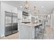 Modern kitchen with stainless steel appliances, an island with bar stools, and white cabinetry at 7056 E 171St St, Noblesville, IN 46062