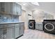 Chic laundry room featuring updated appliances, trendy tile backsplash, and plenty of cabinet space at 7056 E 171St St, Noblesville, IN 46062