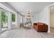 Bright living room with wood floors, modern chandelier, and sliding glass doors at 7056 E 171St St, Noblesville, IN 46062