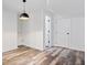 Bright room features wood floors, white walls, and a sleek modern lighting fixture at 7056 E 171St St, Noblesville, IN 46062
