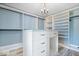 Walk-in closet with custom shelving, an island, and natural light, providing ample storage at 7056 E 171St St, Noblesville, IN 46062
