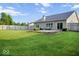 Expansive backyard featuring a well-maintained lawn, patio with outdoor seating, and wooden fence at 7242 Blue Ridge Dr, Noblesville, IN 46062