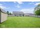 Expansive backyard with lush green grass and a wooden fence, perfect for outdoor activities and privacy at 7242 Blue Ridge Dr, Noblesville, IN 46062