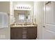 Bright bathroom featuring a double sink vanity with a large mirror and modern lighting fixtures at 7242 Blue Ridge Dr, Noblesville, IN 46062