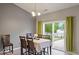 Elegant dining room with a chandelier and a large table for Gathering gatherings next to a sliding glass door at 7242 Blue Ridge Dr, Noblesville, IN 46062