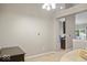 Sitting area showcasing neutral decor, an entry to the kitchen, and a cushioned chair at 7242 Blue Ridge Dr, Noblesville, IN 46062