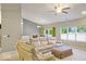 Spacious living room featuring a comfortable sofa, ample natural light, and a ceiling fan at 7242 Blue Ridge Dr, Noblesville, IN 46062