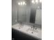 Bathroom featuring double sinks with modern fixtures and mirrors at 732 W 700 N, Fortville, IN 46040