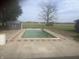 Outdoor pool surrounded by a concrete deck, decorative red brick and adjacent shed at 732 W 700 N, Fortville, IN 46040