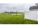 Backyard of homes with a tranquil pond, lush green grass and community space at 747 Tuxedo Dr, Westfield, IN 46074