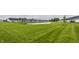 Backyard of homes with a tranquil pond, lush green grass and community space at 747 Tuxedo Dr, Westfield, IN 46074
