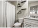 Bathroom featuring white cabinets, granite counters, and floating shelves with decorative accents at 747 Tuxedo Dr, Westfield, IN 46074