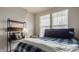 Bedroom with natural light, desk with shelving, and blue bedding for a cozy and modern space at 747 Tuxedo Dr, Westfield, IN 46074
