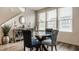 Dining area with a glass table, patterned chairs, and decorative elements near windows at 747 Tuxedo Dr, Westfield, IN 46074