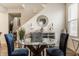 Elegant dining area features a glass table with stylish chairs, decorations, and stairway access at 747 Tuxedo Dr, Westfield, IN 46074