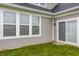 Exterior back view of a home with sliding glass doors and green grass lawn at 747 Tuxedo Dr, Westfield, IN 46074