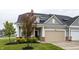 Inviting home exterior showcasing a well-maintained lawn and an attached front-entry garage at 747 Tuxedo Dr, Westfield, IN 46074