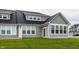 The home features many windows, gray siding, dark roof and a well-manicured lawn at 747 Tuxedo Dr, Westfield, IN 46074