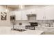 Well-lit kitchen with modern countertops, white cabinets, and sleek stainless steel appliances at 747 Tuxedo Dr, Westfield, IN 46074