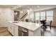 Open kitchen view with an island, stainless steel dishwasher, and dining area near stairs and windows at 747 Tuxedo Dr, Westfield, IN 46074
