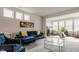Spacious living room featuring a blue sectional sofa, and a large window with plenty of light at 747 Tuxedo Dr, Westfield, IN 46074