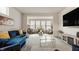 Inviting living room with a blue sectional sofa, modern furniture, and ample natural light at 747 Tuxedo Dr, Westfield, IN 46074