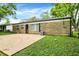 The backyard has a stone facade, patio, and an AC unit at 7625 E 35Th St, Indianapolis, IN 46226