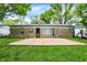 The backyard has a stone facade, patio, and an AC unit at 7625 E 35Th St, Indianapolis, IN 46226