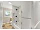 Updated bathroom with a tiled shower-tub combo, modern fixtures, and storage at 7625 E 35Th St, Indianapolis, IN 46226