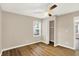 Bedroom with hardwood floors, a ceiling fan, closet, and an entry door at 7625 E 35Th St, Indianapolis, IN 46226