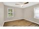 This bedroom features two windows, neutral walls, and laminate flooring at 7625 E 35Th St, Indianapolis, IN 46226