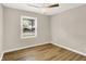 This bedroom features neutral walls, a ceiling fan, and laminate flooring at 7625 E 35Th St, Indianapolis, IN 46226