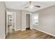 Bedroom with hardwood floors, a ceiling fan, closet, and an entry door at 7625 E 35Th St, Indianapolis, IN 46226